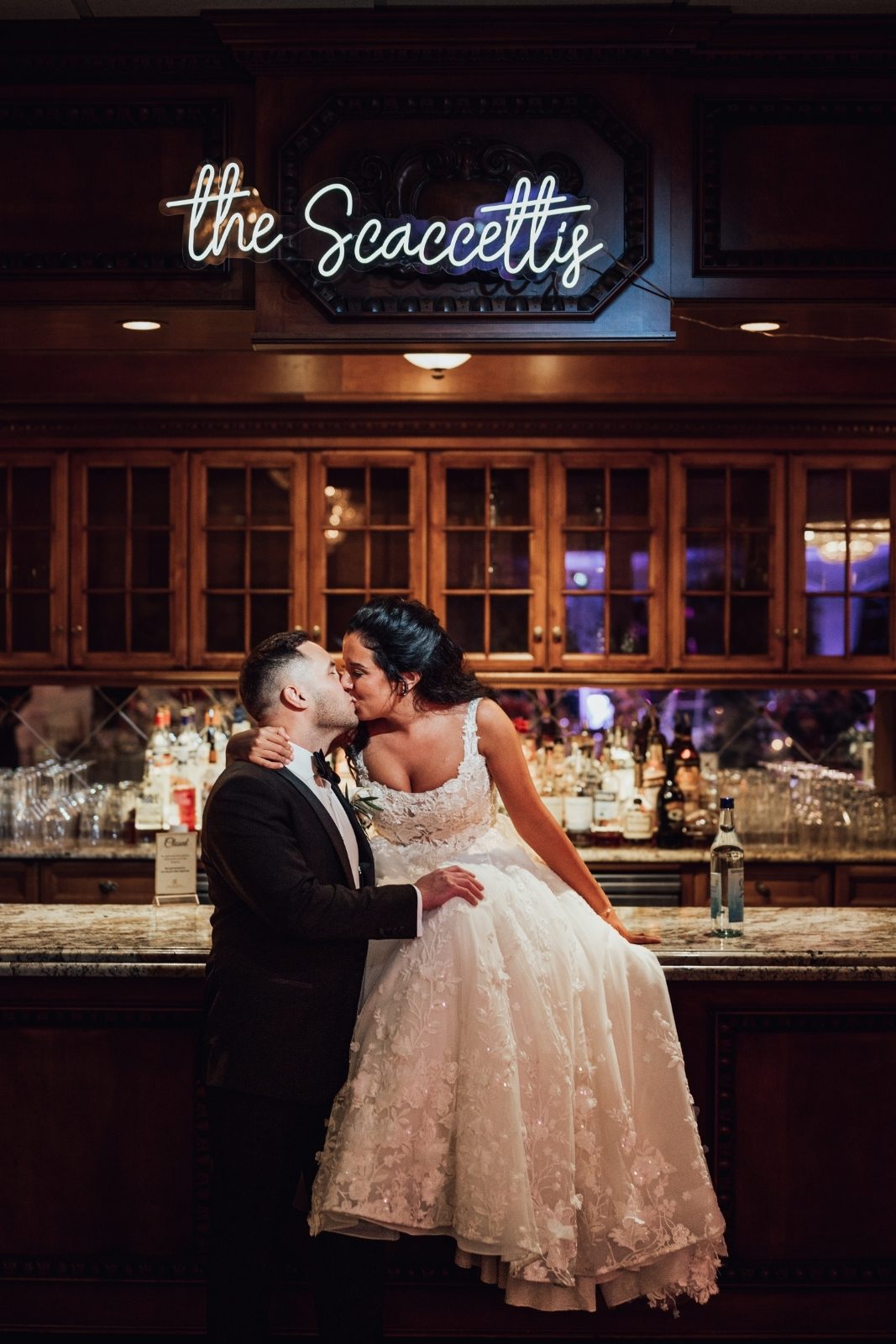 Bride and groom sharing a kiss at the estate bar