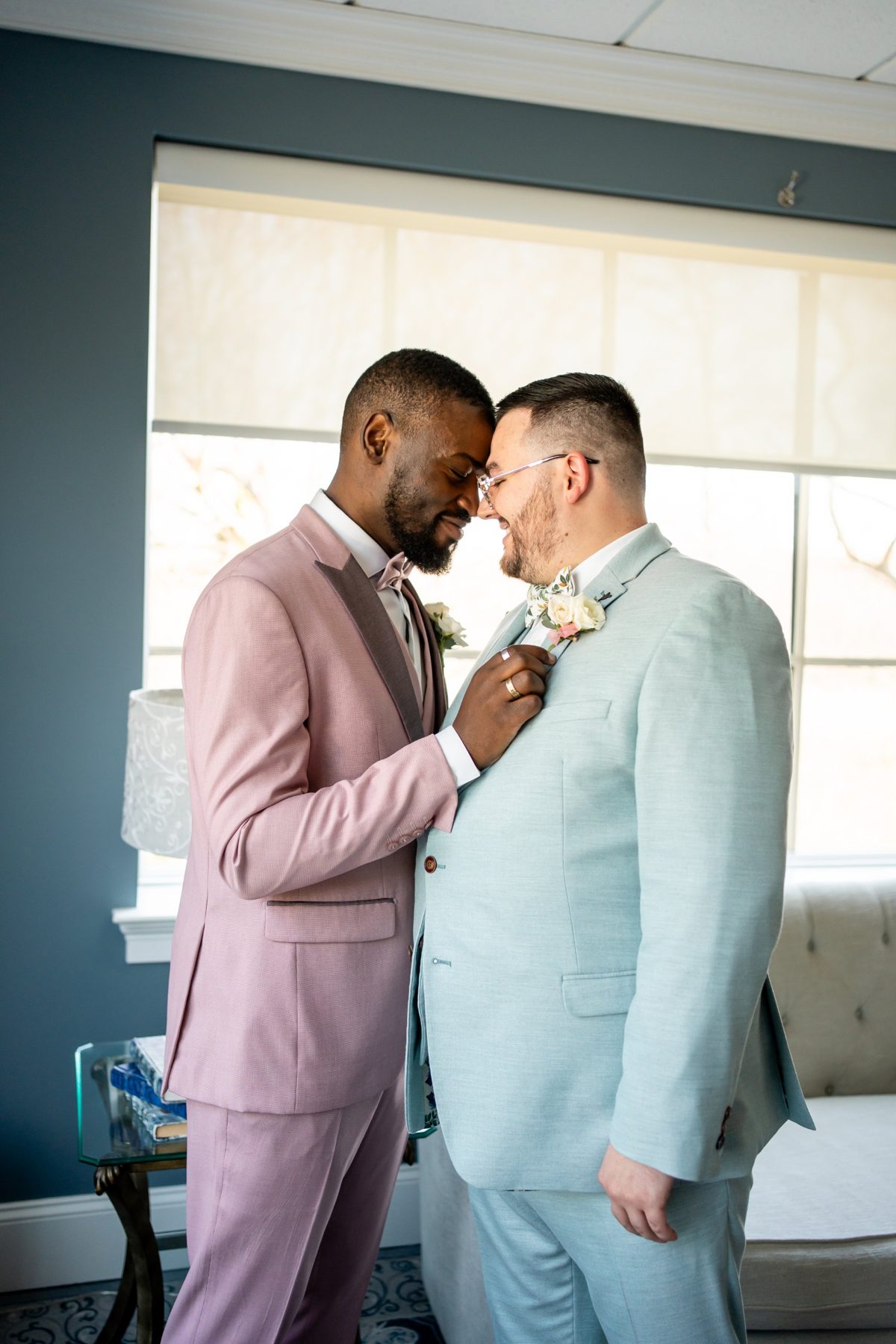 Two grooms sharing a quiet moment in the suite